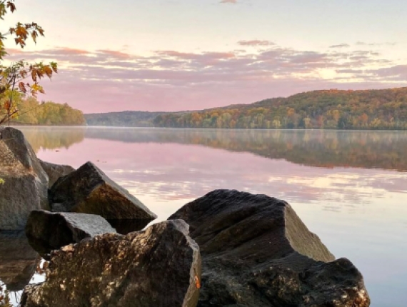 Rocks and water with lake and trees in background (Instagram@the_real_nature_renee)